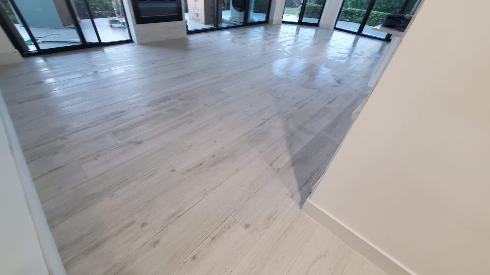 Wood-look porcelain plank floor running through an open great room