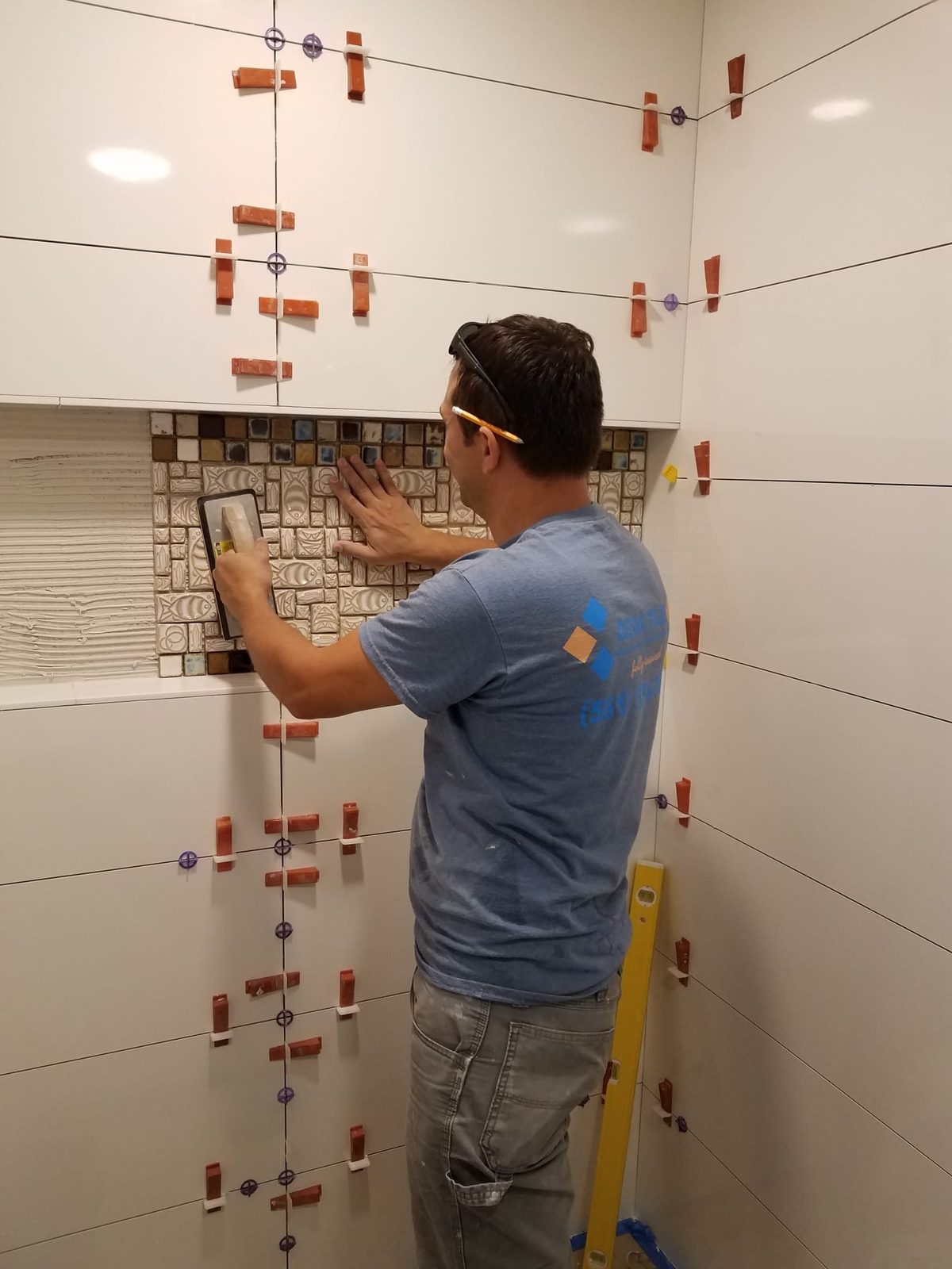 Setting a mosaic accent band into a tiled wall